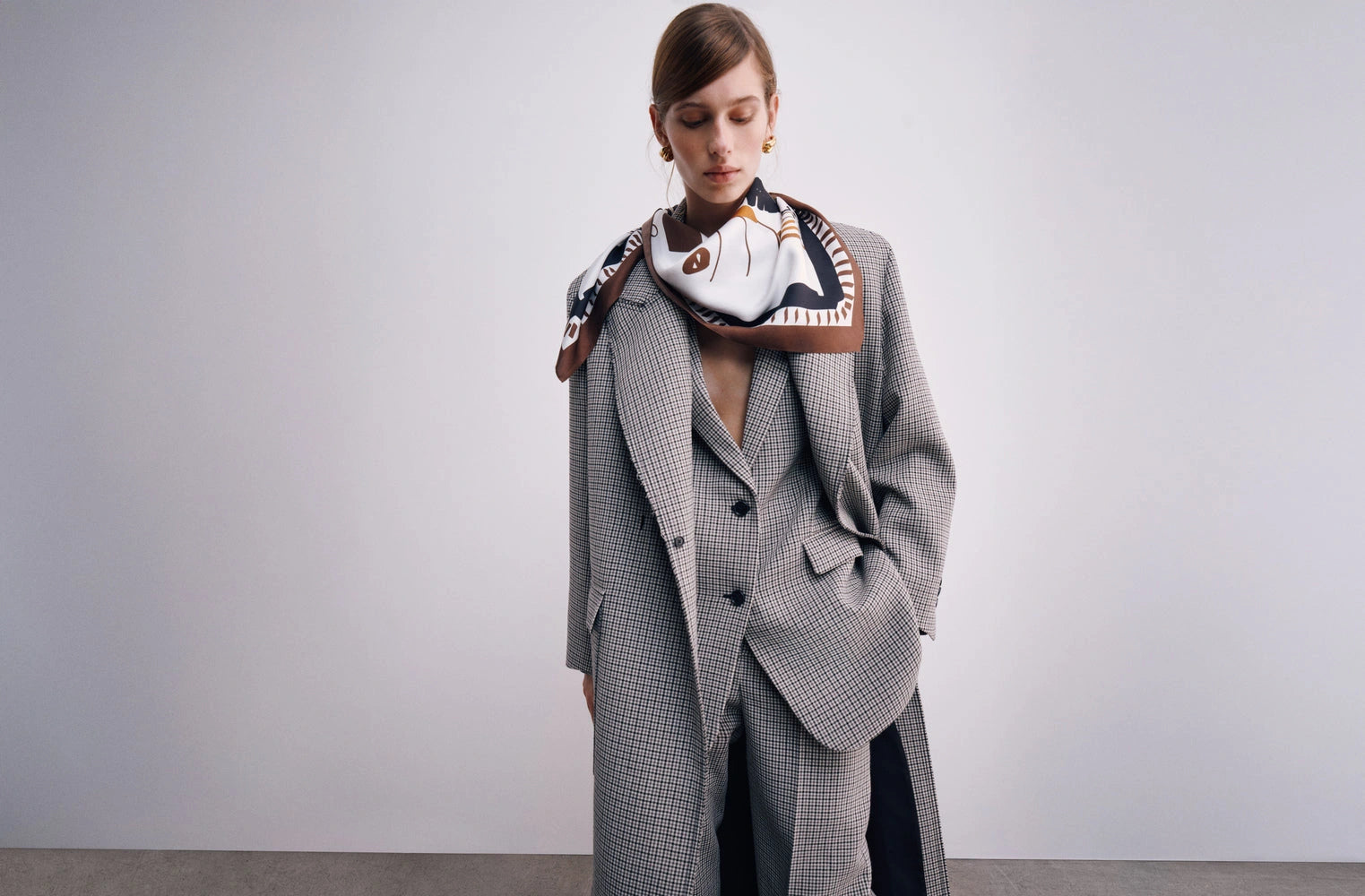 Ports 1961 Pre-Fall 2026 campaign: model in a checked suit and printed silk scarf